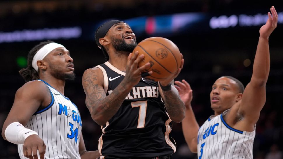 Atlanta Hawks guard Nickeil Alexander-Walker (7) shoots against Orlando Magic guard Desmond Bane (3) during the first half of an NBA basketball game, Monday, March 16, 2026, in Atlanta. (AP Photo/Mike Stewart)