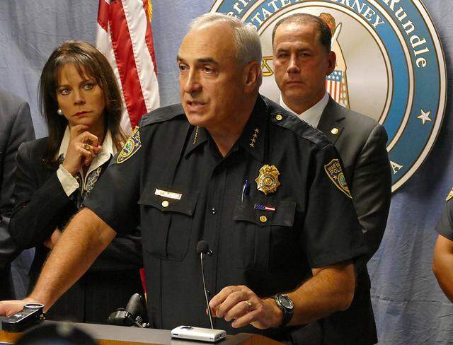 Miami Beach Police Chief Dan Oates (center) speaks alongside State Attorney Katherine Fernandez Rundle and Miami Beach Mayor Philip Levine at a press conference regarding inappropriate emails by members of the Miami Beach Police Department on May 14, 2015.