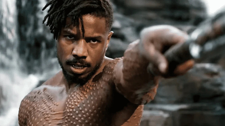 Killmonger with a weapon looking angry in Black Panther