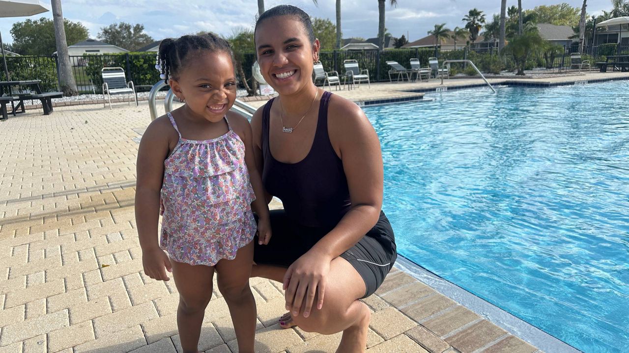 Ms. G’s Swim School owner Genesis Caban (right) with her student, Leilani Jimenez, after a swimming lesson. (Spectrum News/Lizbeth Gutierrez)