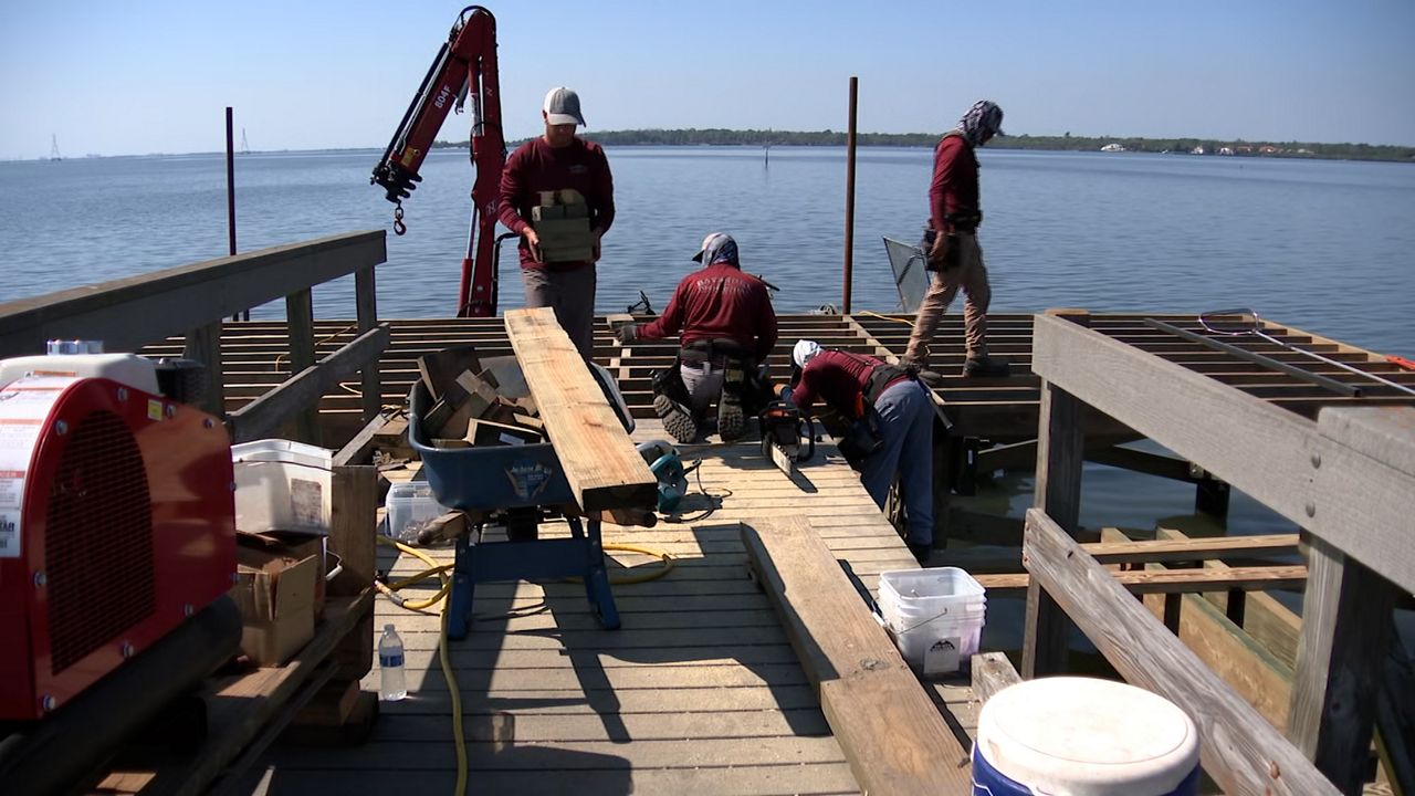 Crews are installing a new frame and deck at the pier in R.E. Olds Park in Oldsmar. The end of the pier was damaged in the 2024 hurricane season. (Spectrum News/Eugene Buenaventura)
