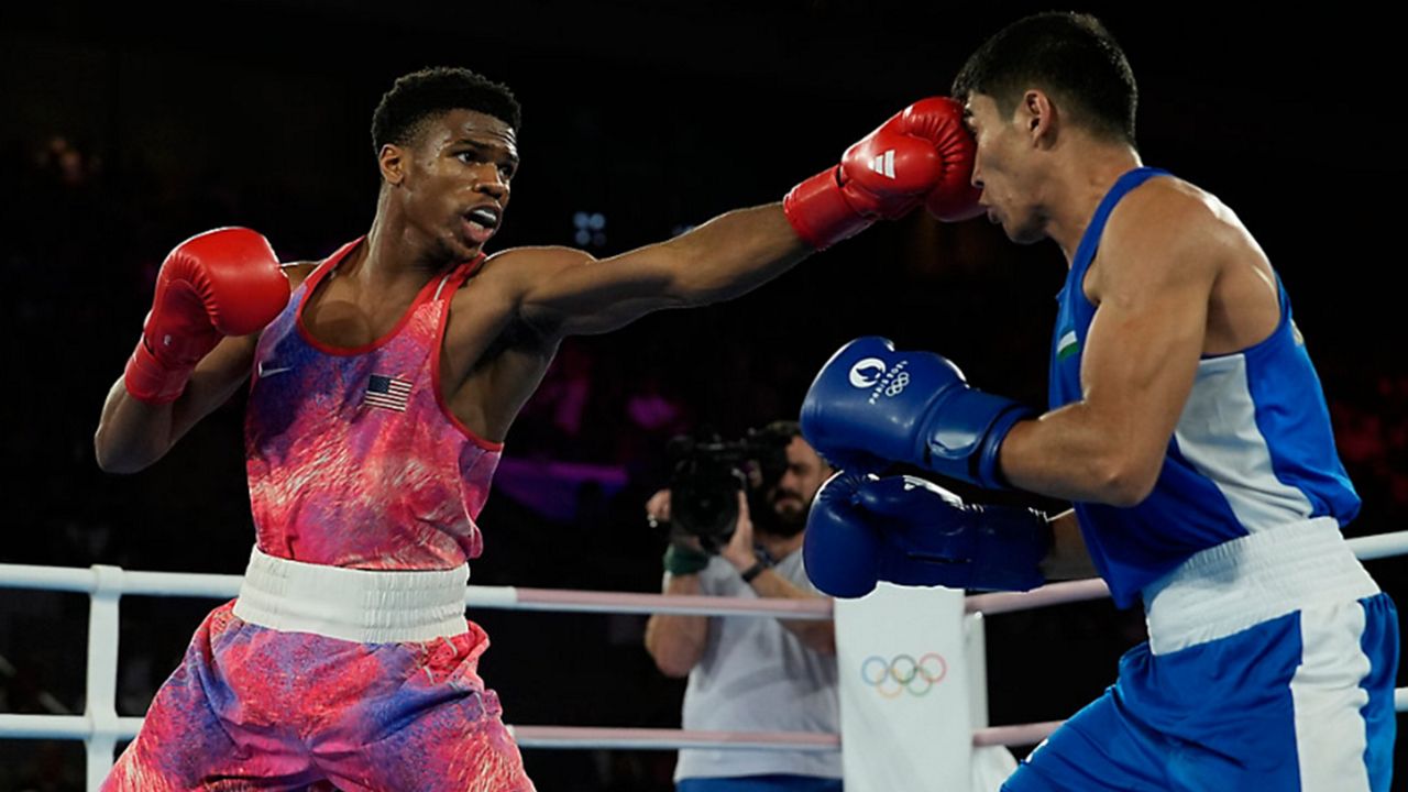 United States' Omari Jones, left, fights Uzbekistan's Asadkhuja Muydinkhujaev in their men's 71 kg semifinal boxing match at the 2024 Summer Olympics, Tuesday, Aug. 6, 2024, in Paris, France. (AP Photo/John Locher)