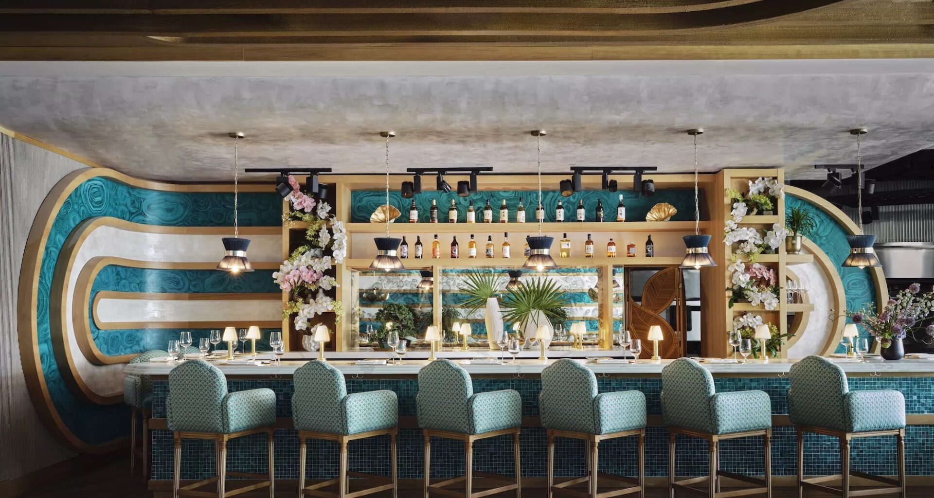 a midcentury style bar with six plush chairs