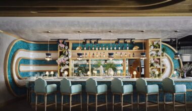 a midcentury style bar with six plush chairs