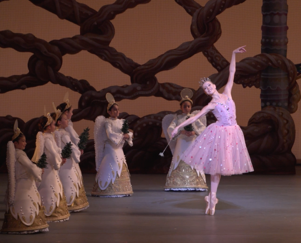 photo of Miami City Ballet principal dancer Dawn Atkins dancing in The Nutcracker, surrounded by young dancers dressed as angels