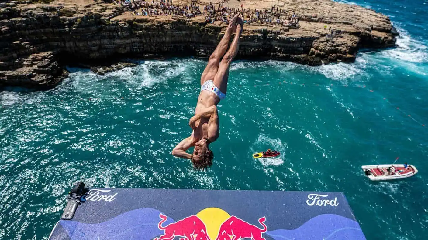 Man in swimsuit, jumping into water