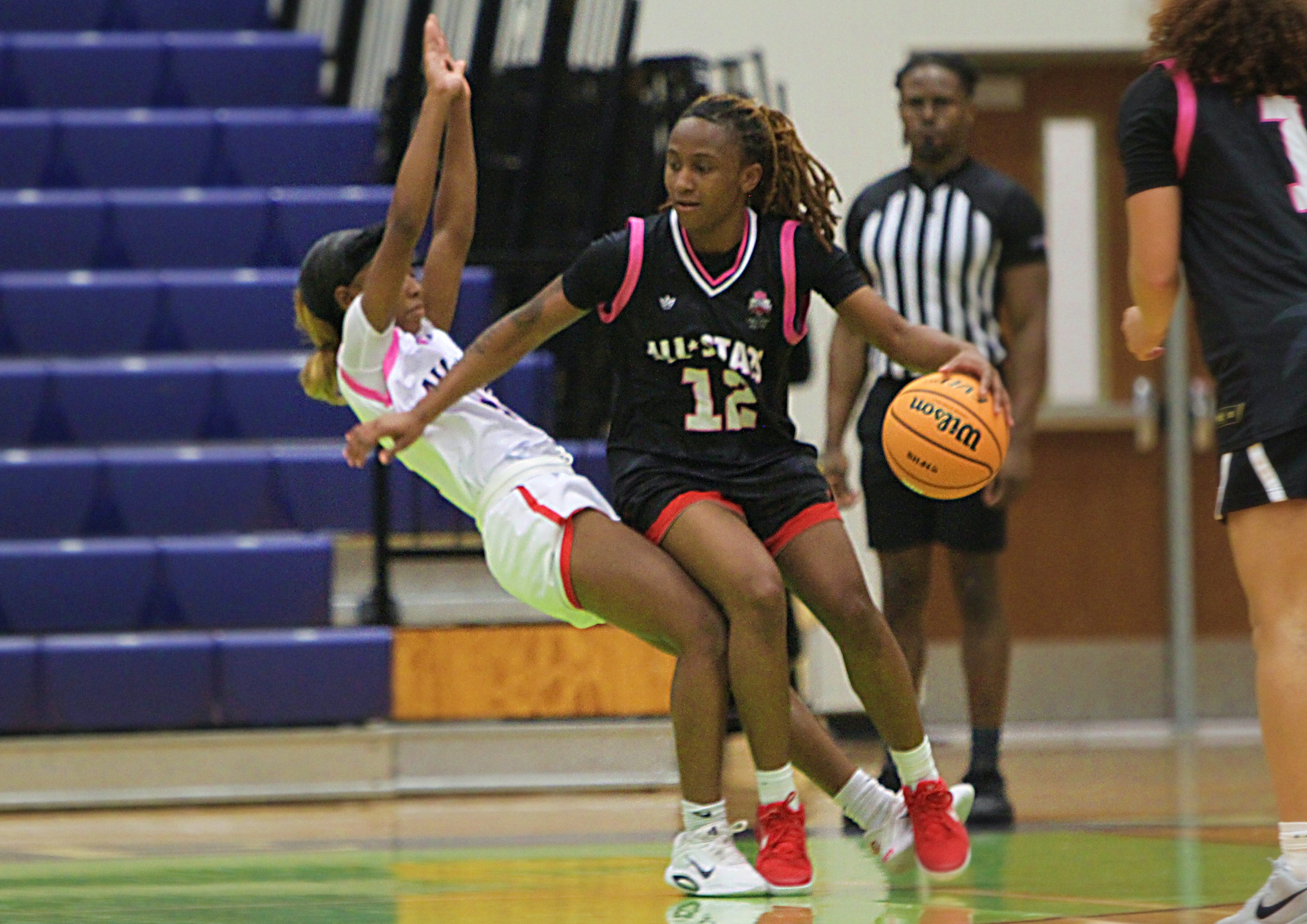 Cherish Risbrook of Colonial draws a charging foul from Maliyah...