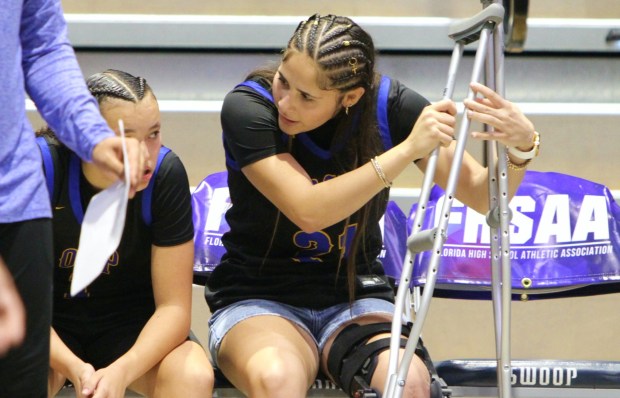 Orlando Christian Prep leading scorer Rosemarie Lisojo had to watch from the bench with crutches and a knee brace as her teammates fell to Grandview 71-36 in the Class 1A girls state basketball game at UNF Arena in Jacksonville on Saturday, march 7, 2026. (Chris Hays/Orlando Sentinel)