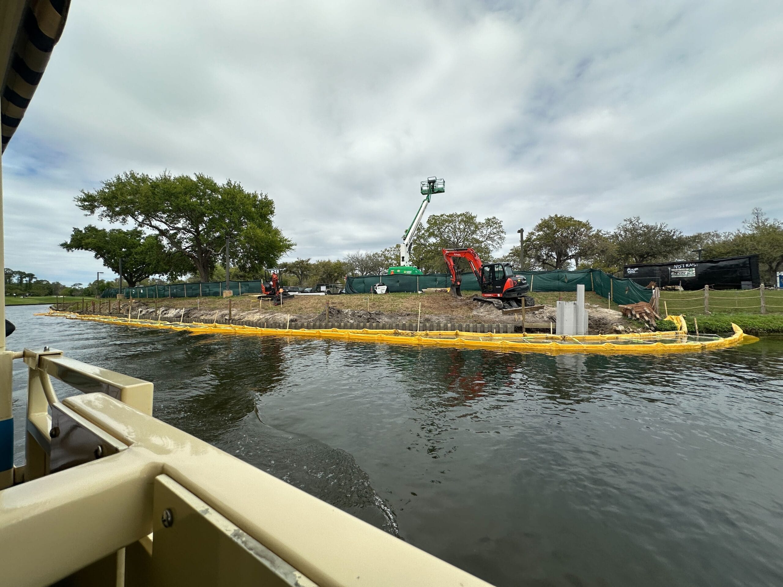 Other parts of the wall section have new yellow boundary markers placed alongside them. Pieces of construction equipment were placed near one section of the wall.