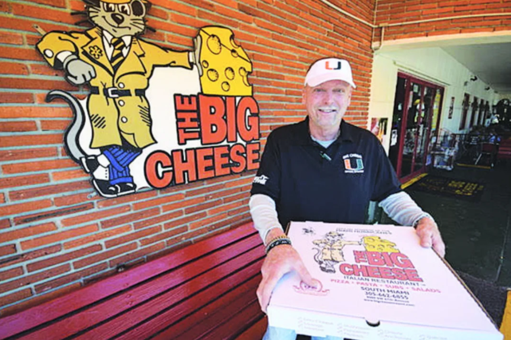a man holding a cheese box