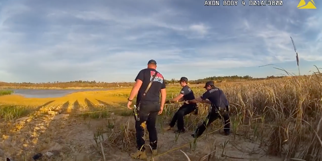 Watch: Man buried to his shoulders in quick sand is rescued in Florida