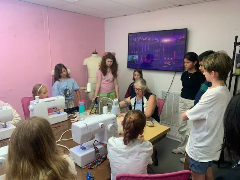 Children learning how to sew