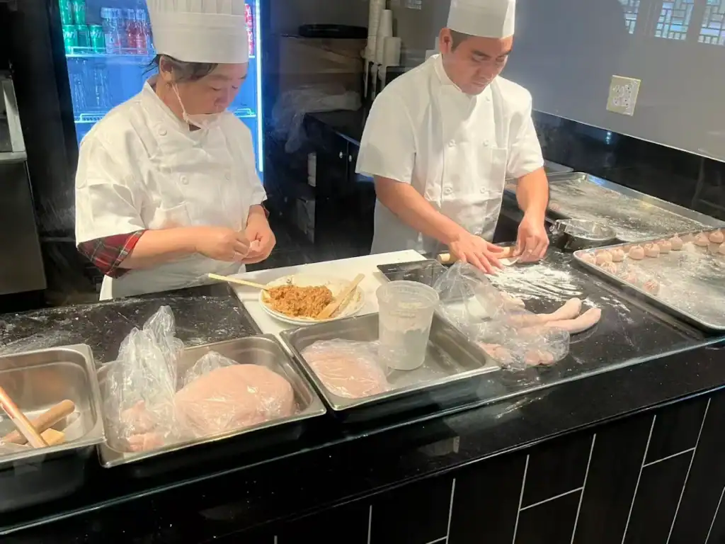 People cooking dumplings