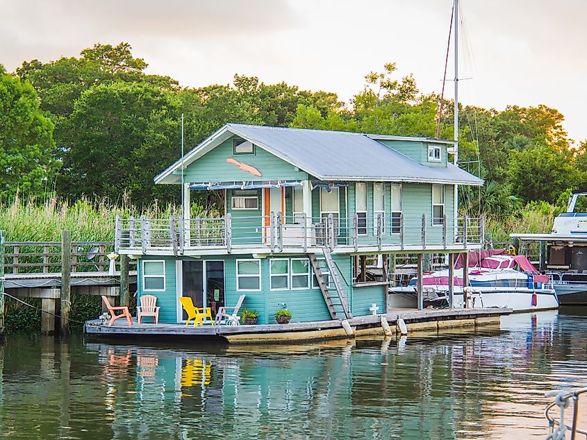 Colorful houseboat residence docked on Apalachicola Bay in the town of Apalachicola, Florida.