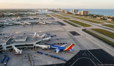 Aerial view of Fort Lauderdale airport with a Southwest jet and beachfront hotels at sunset.
