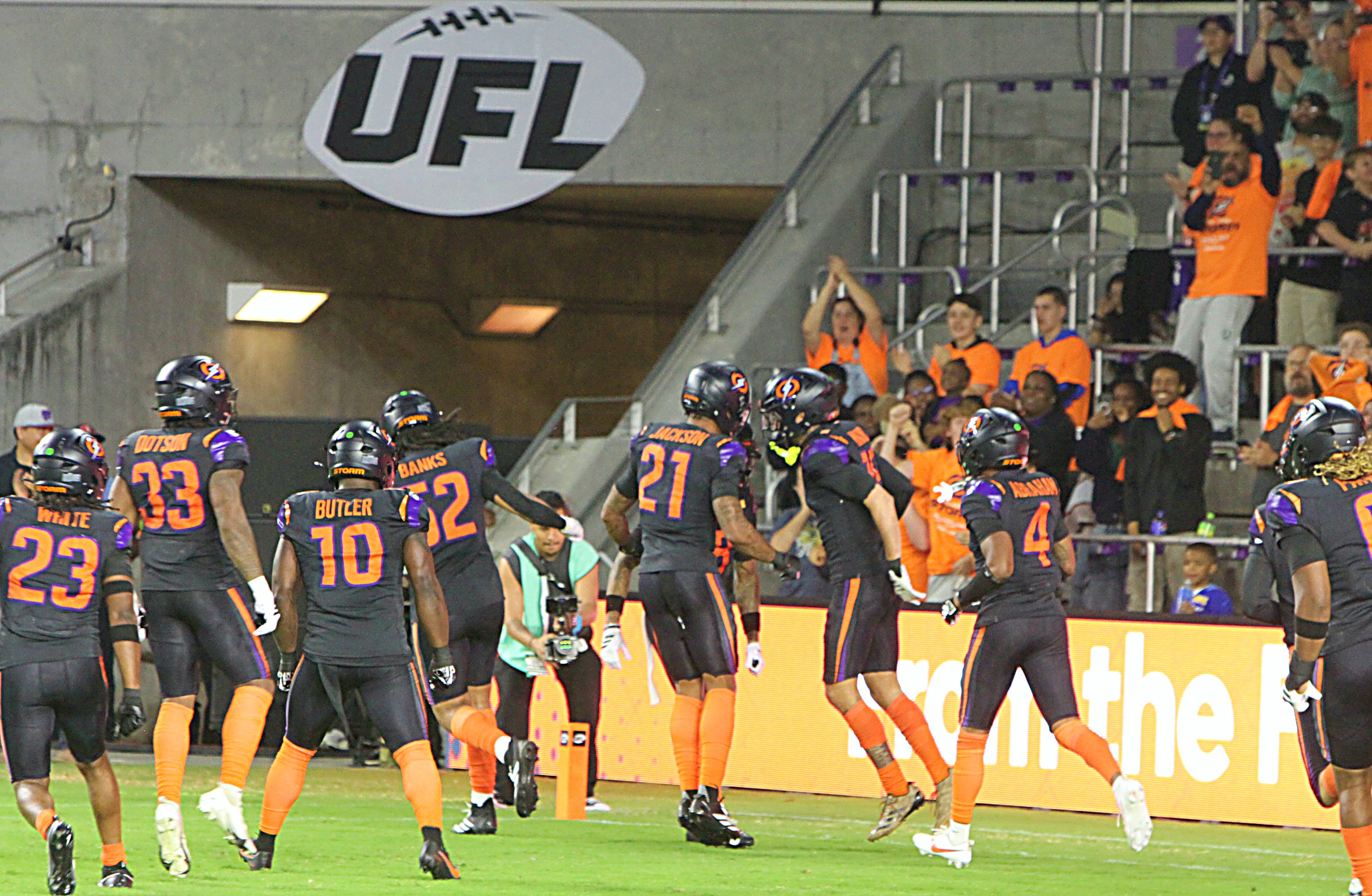 Orlando Storm players celebrate Josh Minkins' opening kickoff fumble recovery...