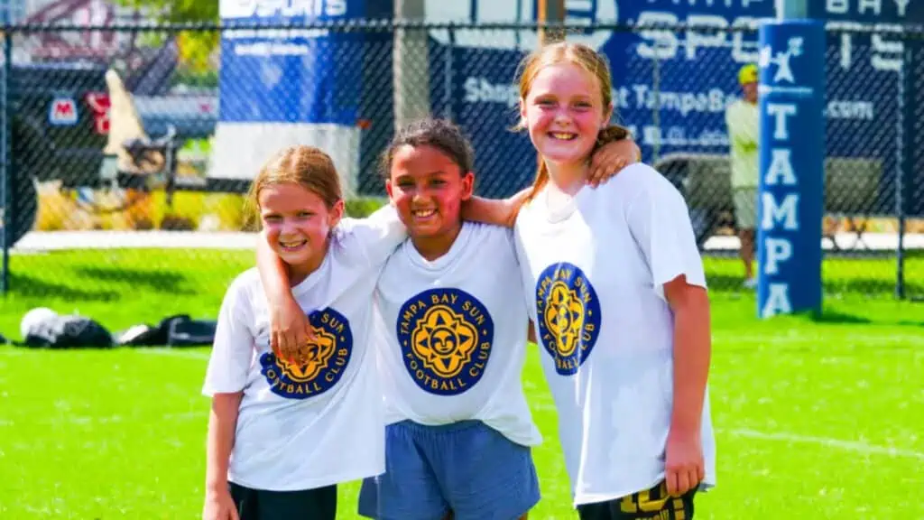 Girls at a soccer camp smiling