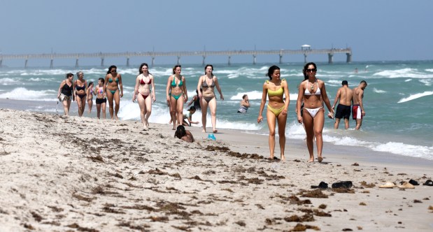 People enjoy the beach in Hollywood on Monday, March 16, 2026. (Carline Jean/South Florida Sun Sentinel)