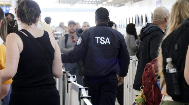 A TSA agent directs passengers through a security checkpoint at Fort Lauderdale-Hollywood International Airport on Monday, March 23, 2026.