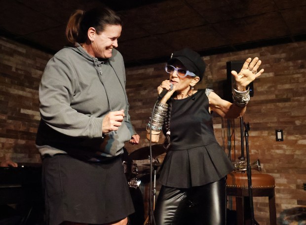 Jen Hapanowicz, left, of Connecticut, joins performer Ginetta Vendetta on stage at Bar Betty in Fort Lauderdale on Monday, Feb. 23, 2026. (Carline Jean/South Florida Sun Sentinel)
