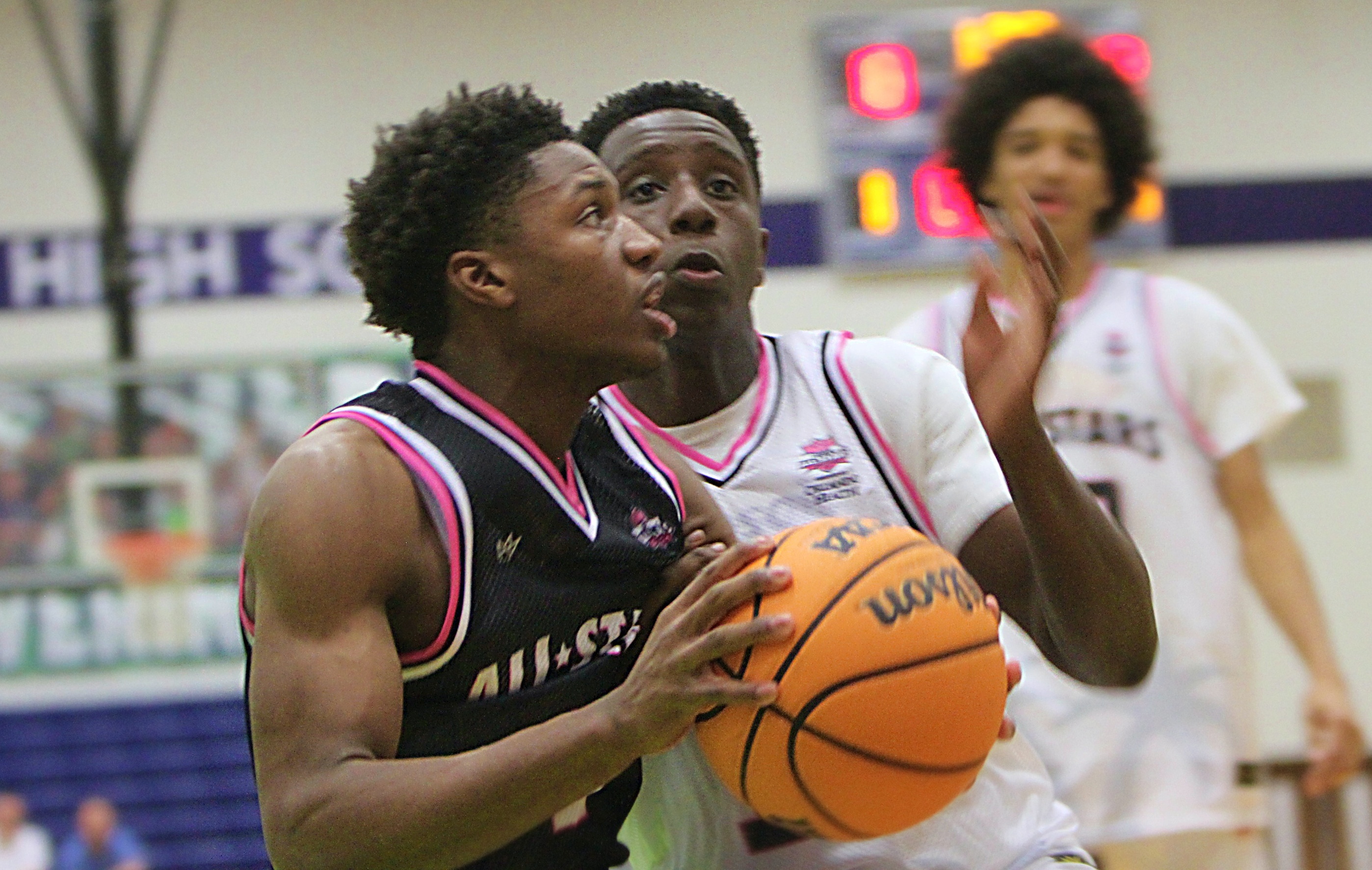 Josh Theus of Orlando Christian Prep drives past Zacarick Davis...