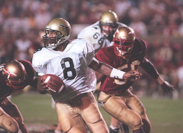 Quarterback Daunte Culpepper, shown scrambling during a UCF game against top-ranked FSU in 1995, was the first big-time football recruit to sign with UCF. During his tenure UCF moved to Division I-A, making the Knights the first football program to play in all four NCAA football divisions, III, II, I-AA and I-A. (Orlando Sentinel file)
