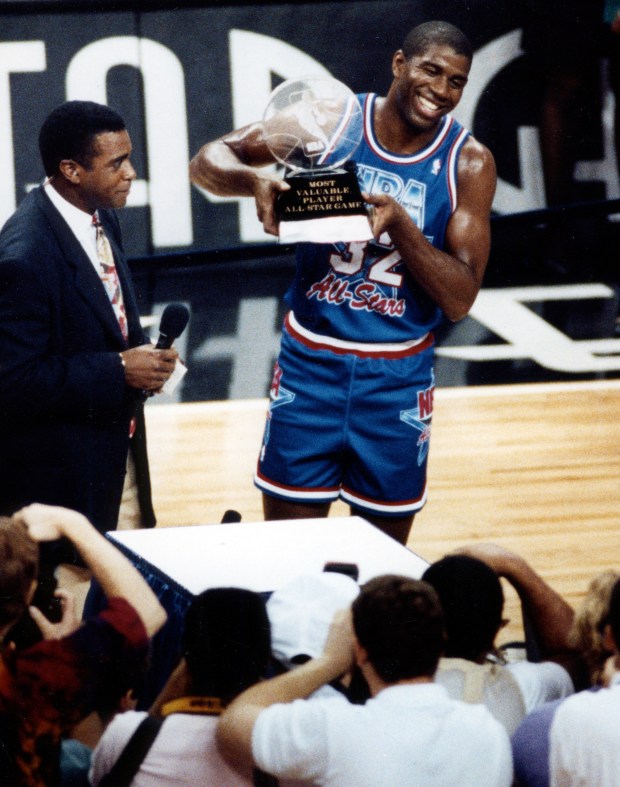 Magic Johnson holds the MVP trophy after the 1992 NBA All-Star Game at the Orlando Arena in Orlando, Florida. Johnson won the MVP award after winning memorable one-on-one showdowns with Isiah Thomas and Michael Jordan and then sinking a long three pointer to close the game. (Gary Bogdon/Orlando Sentinel)