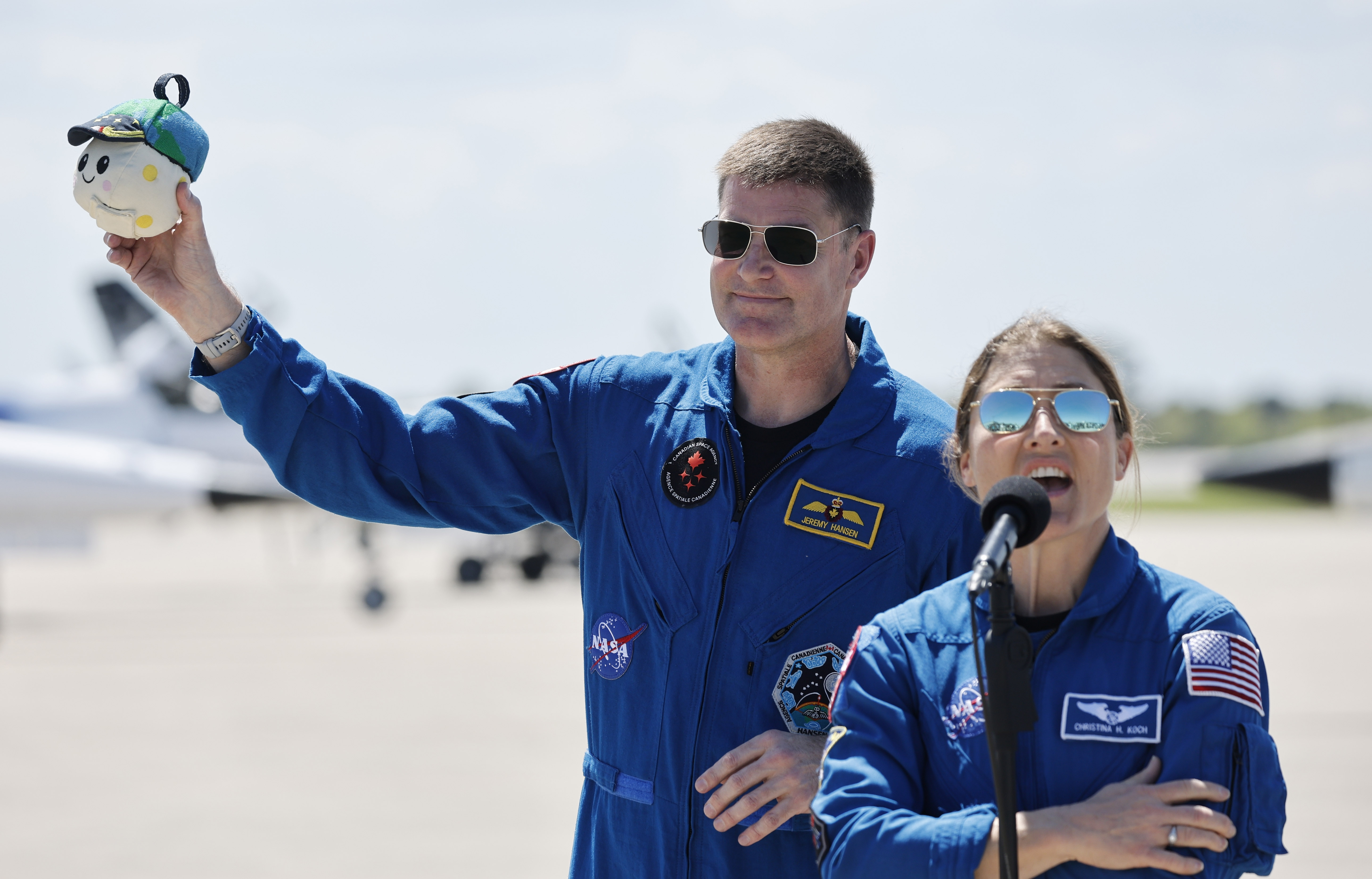 Artemis mission specialist Jeremy Hansen holds up the Zero-G indicator...