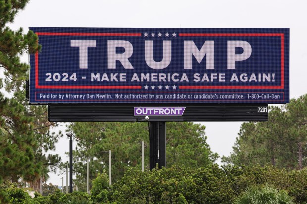 Electronic billboards advertisements for attorney Dan Newlin, and political advertisements for Donald Trump also paid by for the attorney; along I-4 near the Conroy Road Exit 78, on Wednesday, July 10, 2024. (Ricardo Ramirez Buxeda/ Orlando Sentinel)