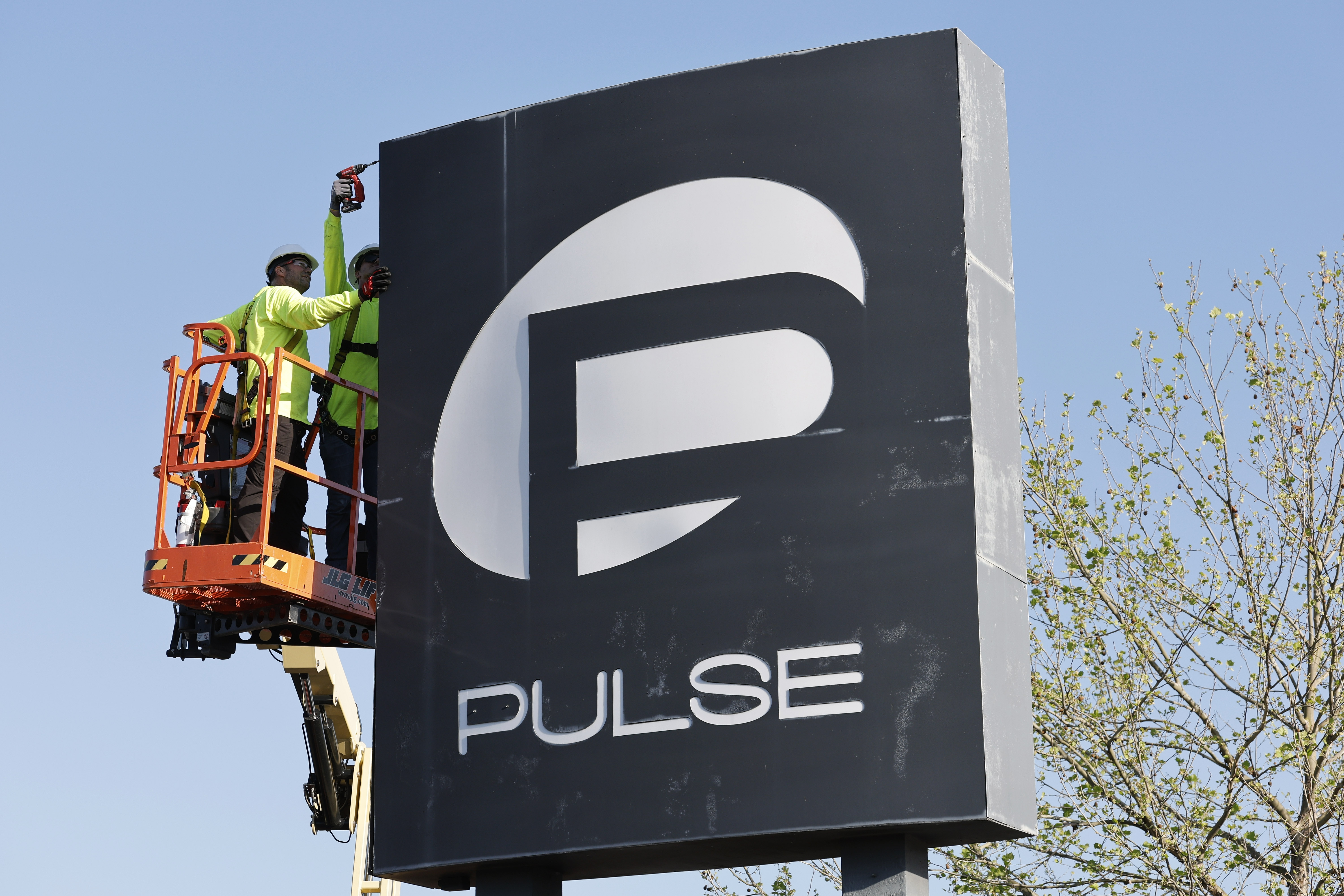 Workers begin the process of taking down the Pulse nightclub...