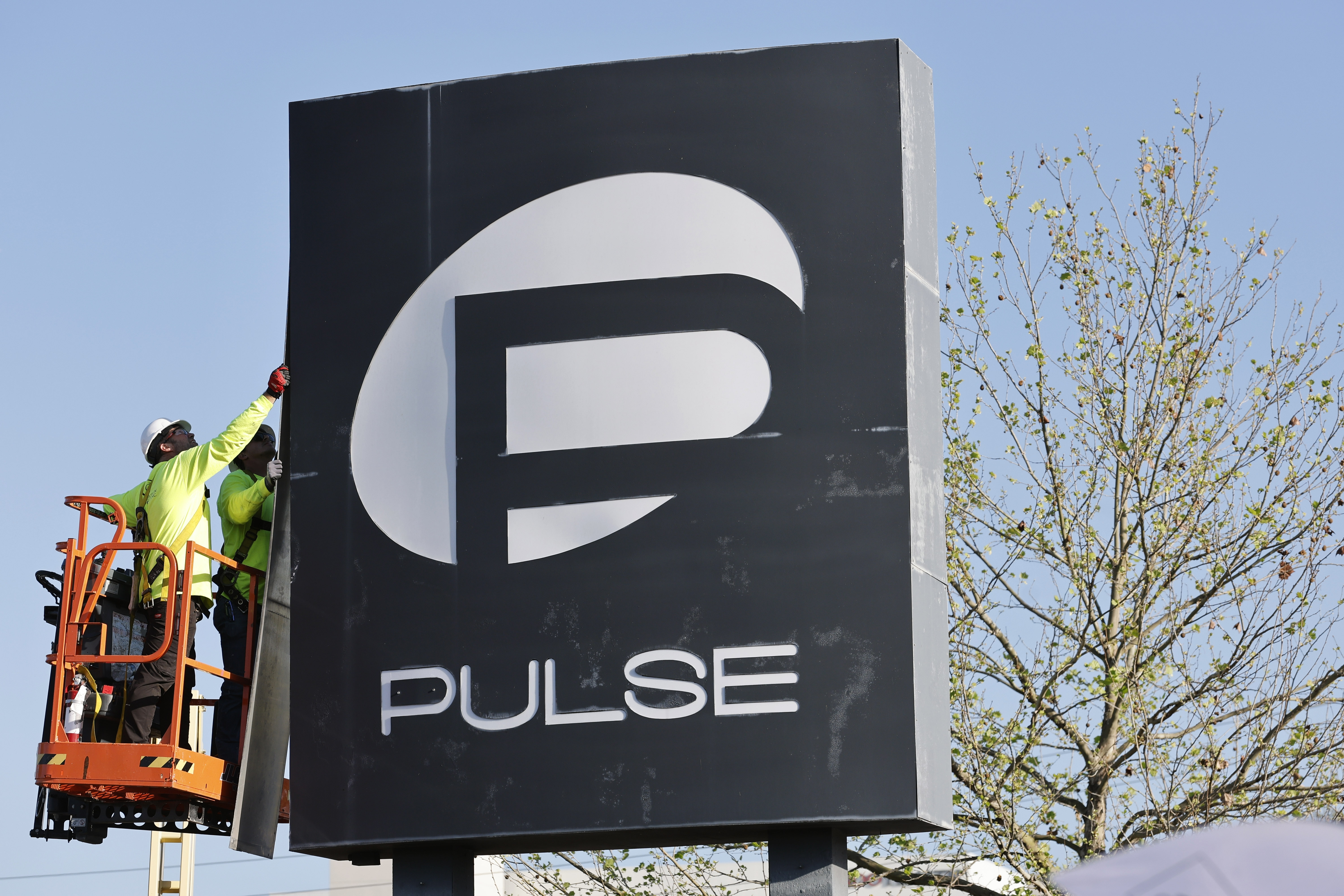 Workers begin the process of taking down the Pulse nightclub...