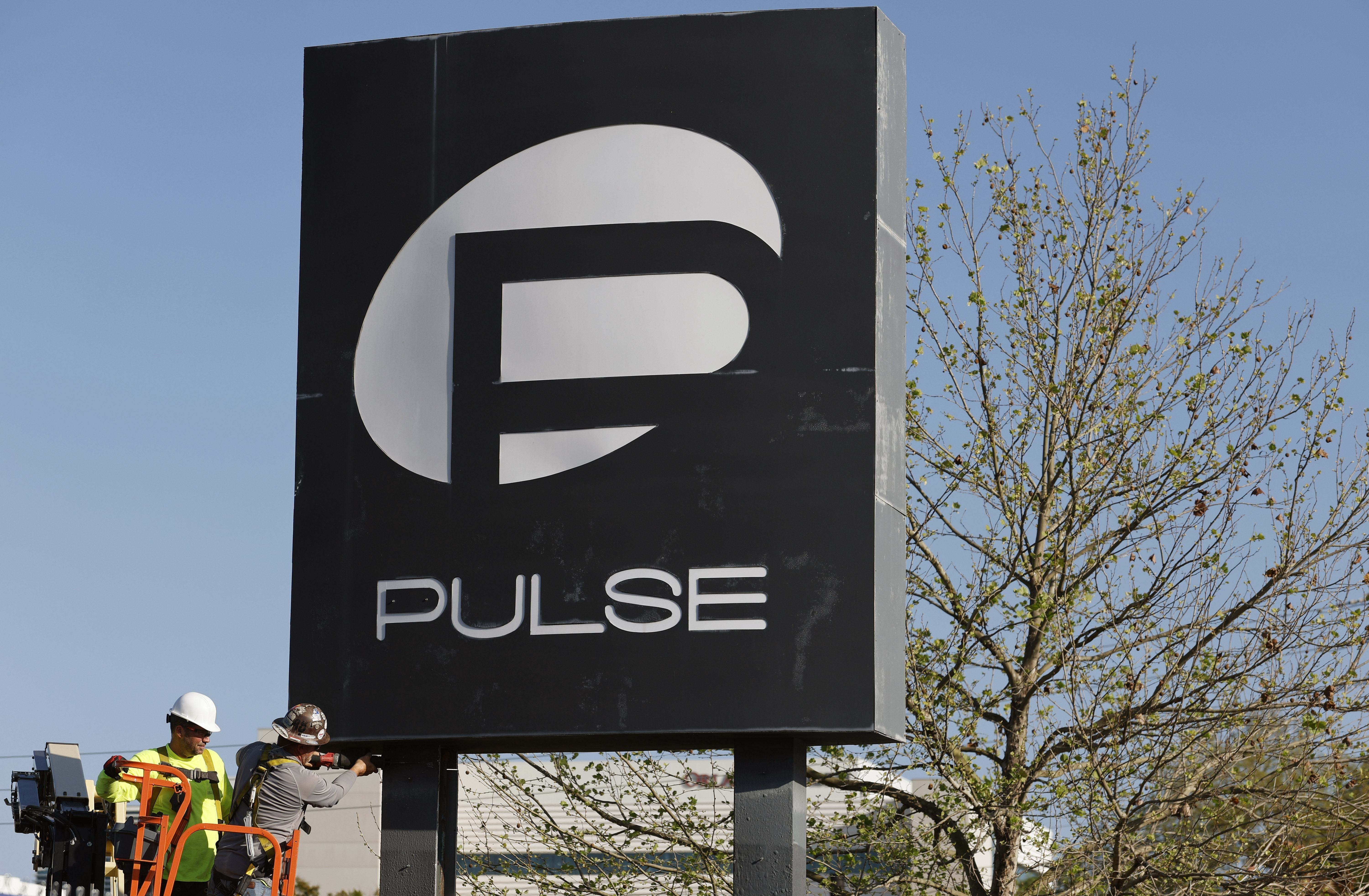 Workers begin the process of taking down the Pulse nightclub...