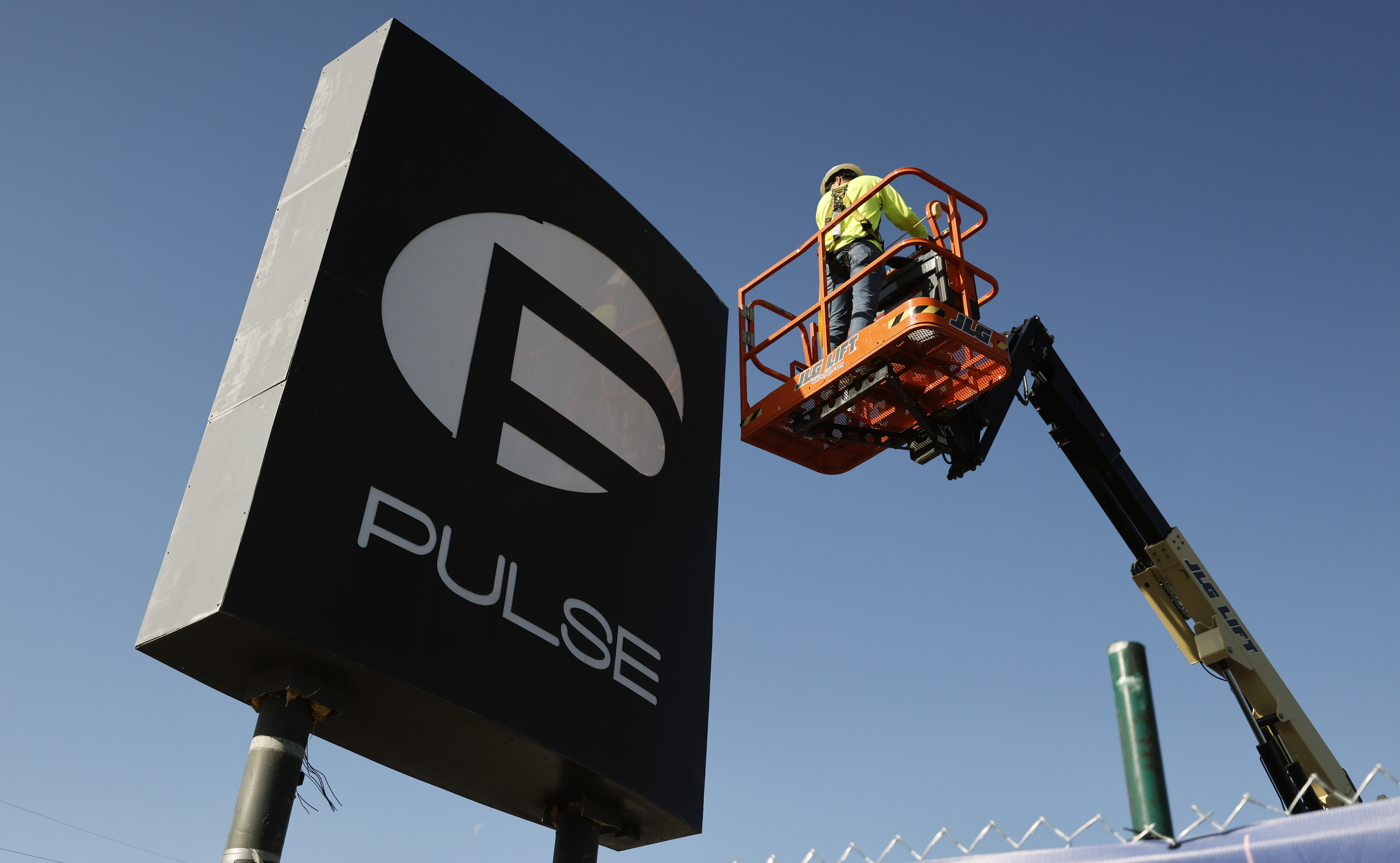 Workers begin the process of taking down the Pulse nightclub...