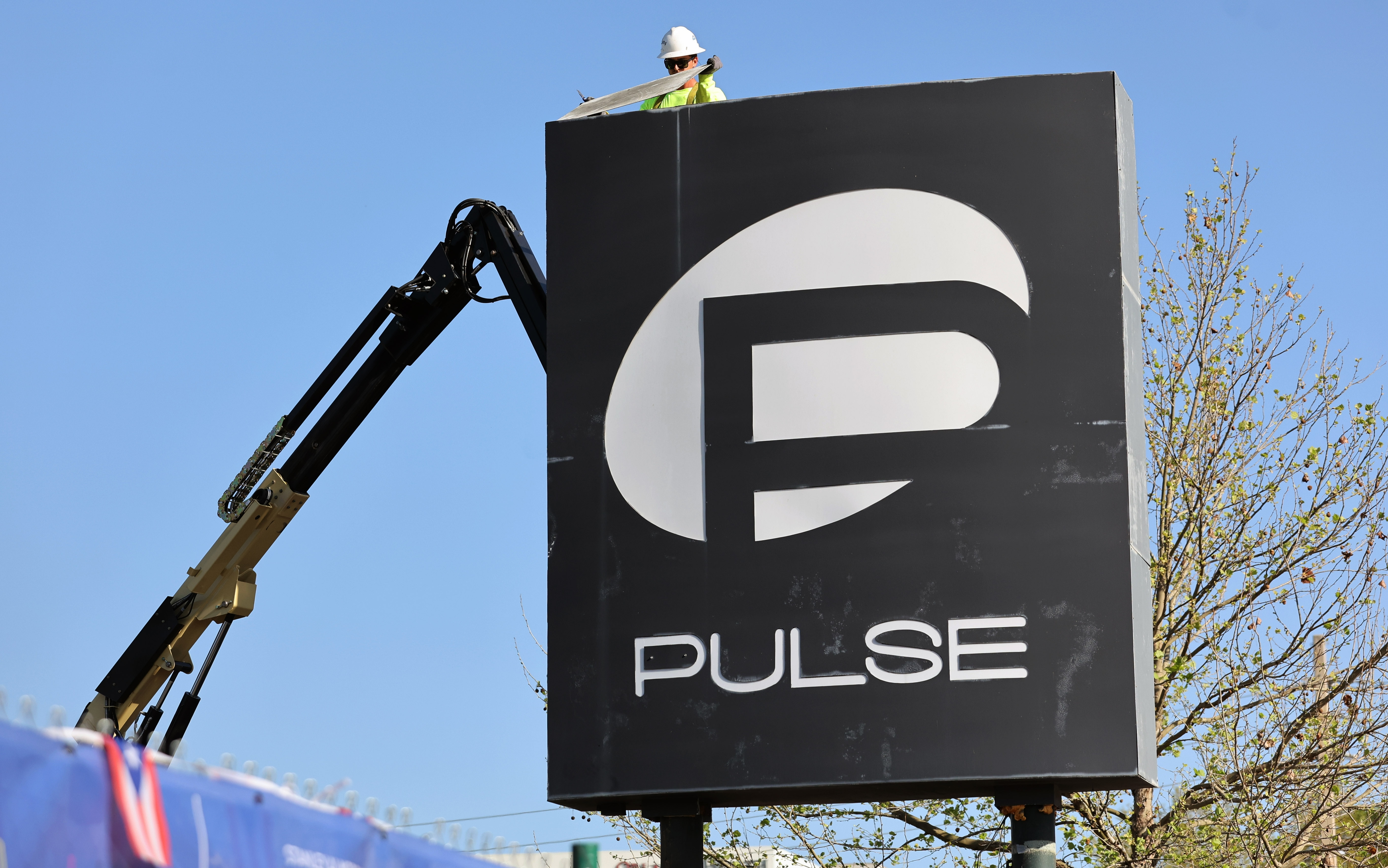 Workers begin the process of taking down the Pulse nightclub...