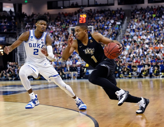 UCF guard BJ Taylor (1) drives down the baseline while defended by Duke's Cam Reddish (2) during the first half of the second-round game of the 2018-19 NCAA Tournament in Columbia, S.C., on Sunday, March 24, 2019. (AP File Photo/Richard Shiro) 