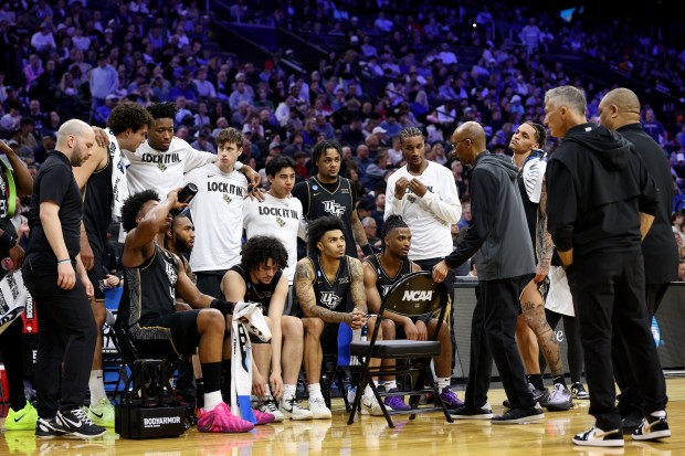 Head coach Johnny Dawkins of the UCF Knights gathers his players against the UCLA Bruins during the second half in the first round of the 2026 NCAA Men's Basketball Tournament at Xfinity Mobile Arena on March 20, 2026 in Philadelphia, Pennsylvania. (Photo by Emilee Chinn/Getty Images)