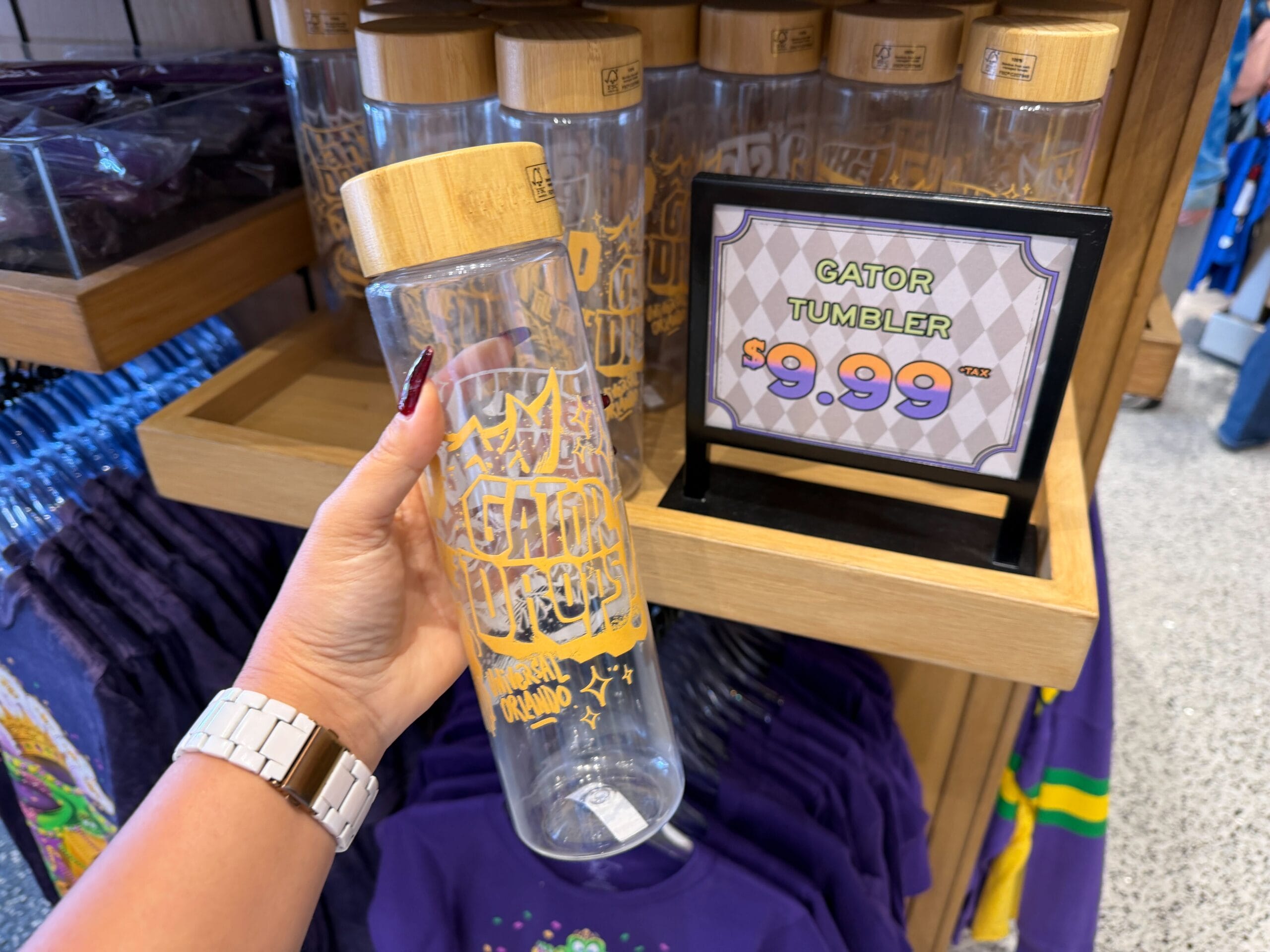 The clear plastic tumbler has a wood top with a yellow King Gator "Party don't stop till the gator drops!" design.