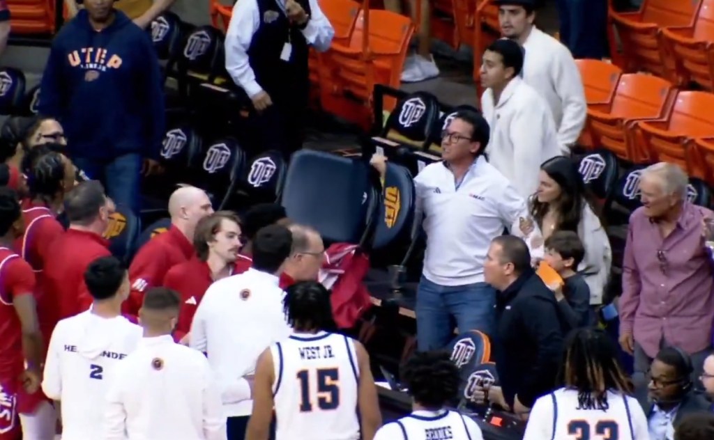 An angry UTEP fan picks up a chair and gestures toward Jacksonville State players after a men's college basketball game on March 7, 2026.