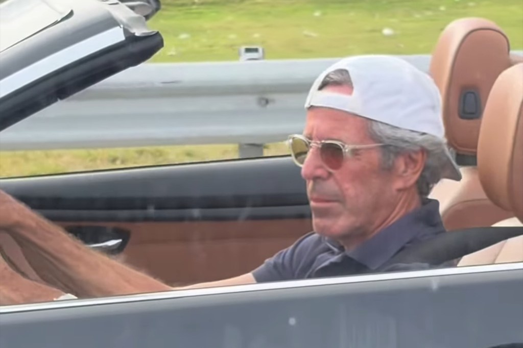 A man resembling Jeffrey Epstein drives a convertible car.