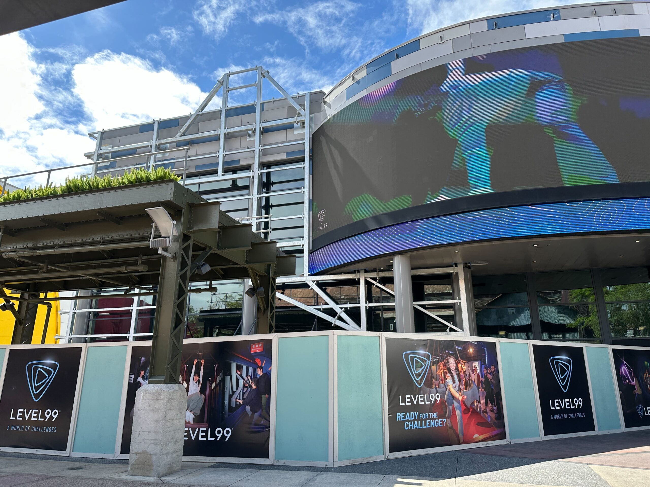 Construction walls and planters continue to block the entrance to Level99. The walls are decorated with concept art for the upcoming location.