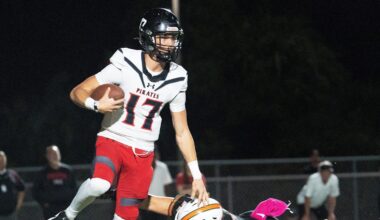 Logan Flaherty, the quarterback of Port Charlotte eludes a Dunbar defender during a game at Dunbar on Friday, Oct. 10, 2025. Port Charlotte won.