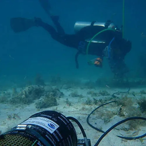 Taylor Gill maintains sensors as the Sami pH (bottom left) logger actively measures changes in ocean pH.