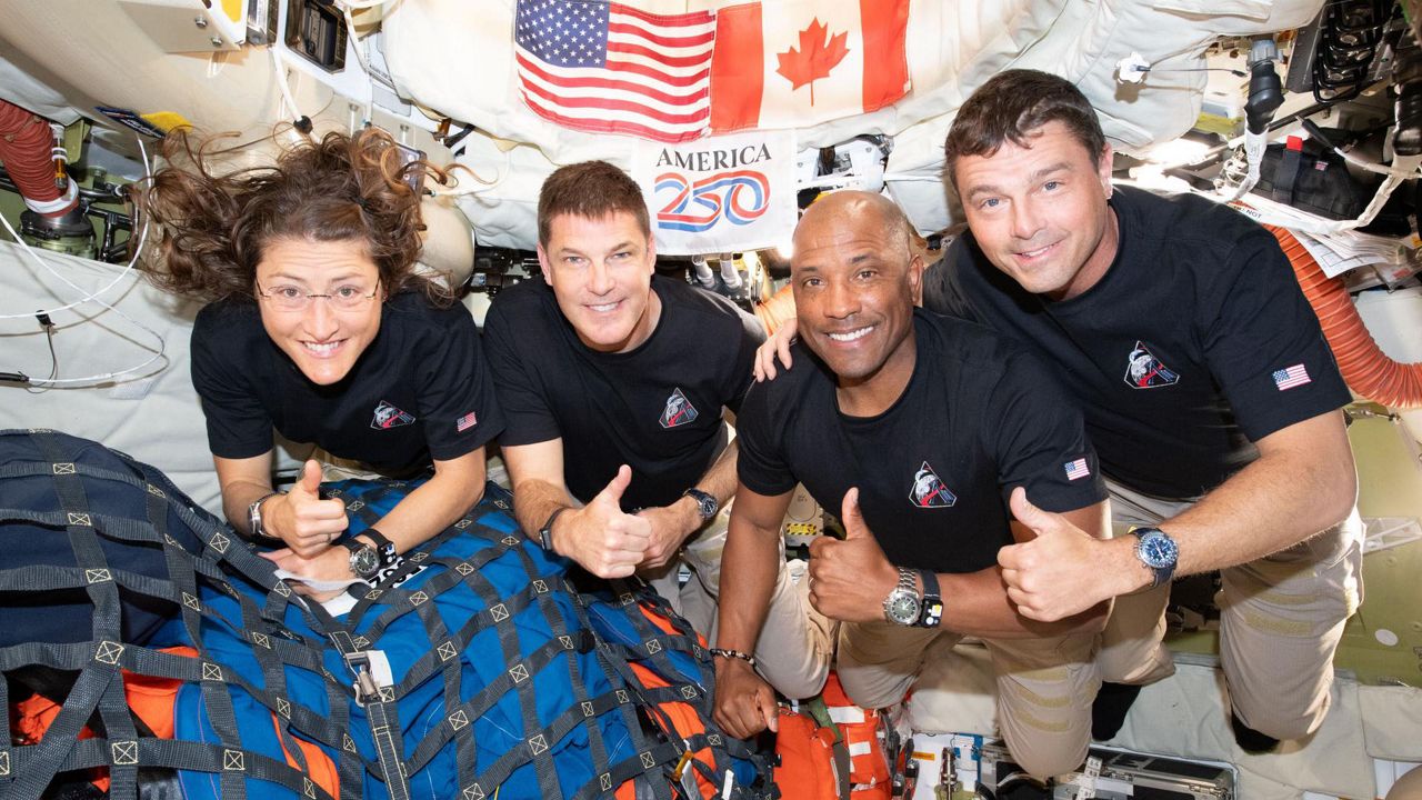 The Artemis II crew mission specialist Christina Koch, left, mission specialist Jeremy Hansen, pilot Victor Glover, and Cmdr. Reid Wiseman gives the thumbs up as they head home back to Earth after doing a flyby mission of the moon. (NASA)