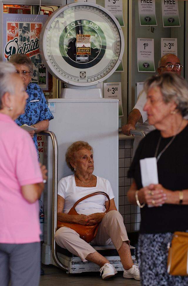 In this file photo from Oct. 12, 2004, customers wait outside the Publix supermarket in the 183 block of Pines Boulevard in Pembroke Pines, for flu shots.