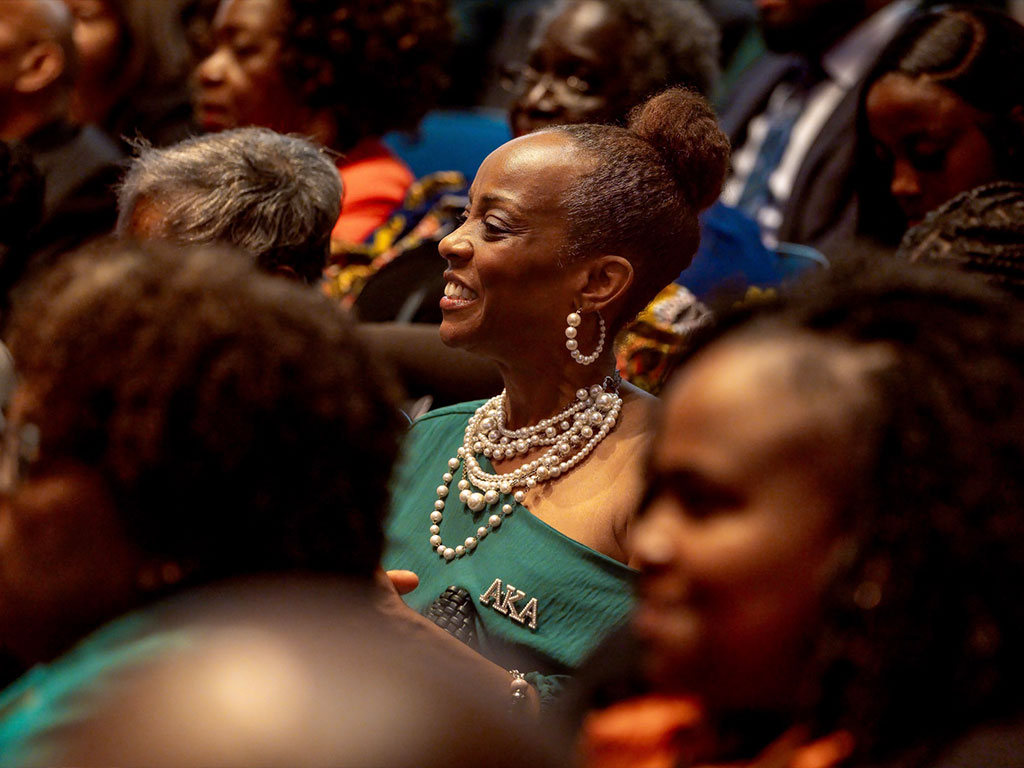 An AKA in the crowd smiling