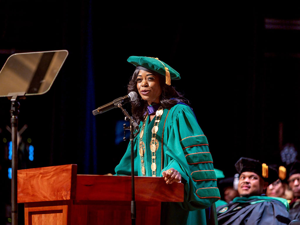 President Marva B. Johnson, J.D. at the podium. 