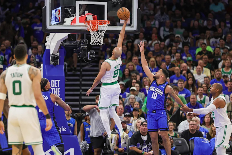 Apr 25, 2025; Orlando, Florida, USA; Boston Celtics guard Derrick White (9) goes to the basket in front of Orlando Magic guard Cory Joseph (10) during the second quarter of game three of first round for the 2024 NBA Playoffs at Kia Center. Mandatory Credit: Mike Watters-Imagn Images
