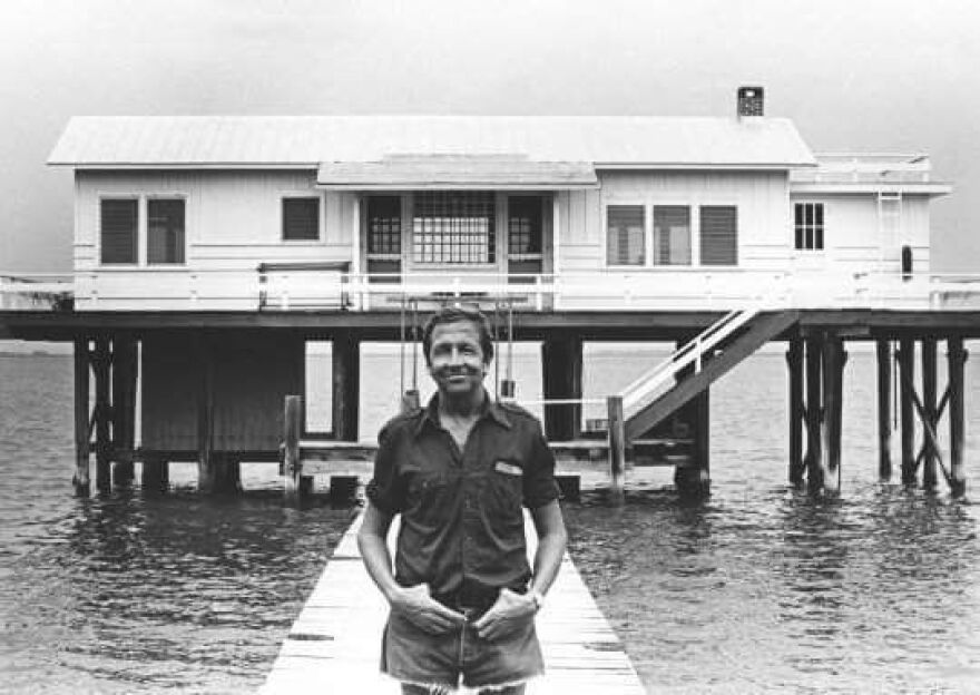 Artist Bob Rauschenberg poses in front of the Fish House he purchased in 1978.