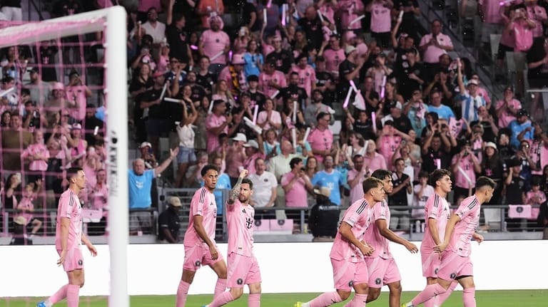 Inter Miami forward Lionel Messi, third left, celebrates with teammates...
