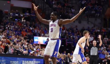 Rueben Chinyelu and Boogie Fland jump to defend a shot from Arkansas' Darius Acuff.